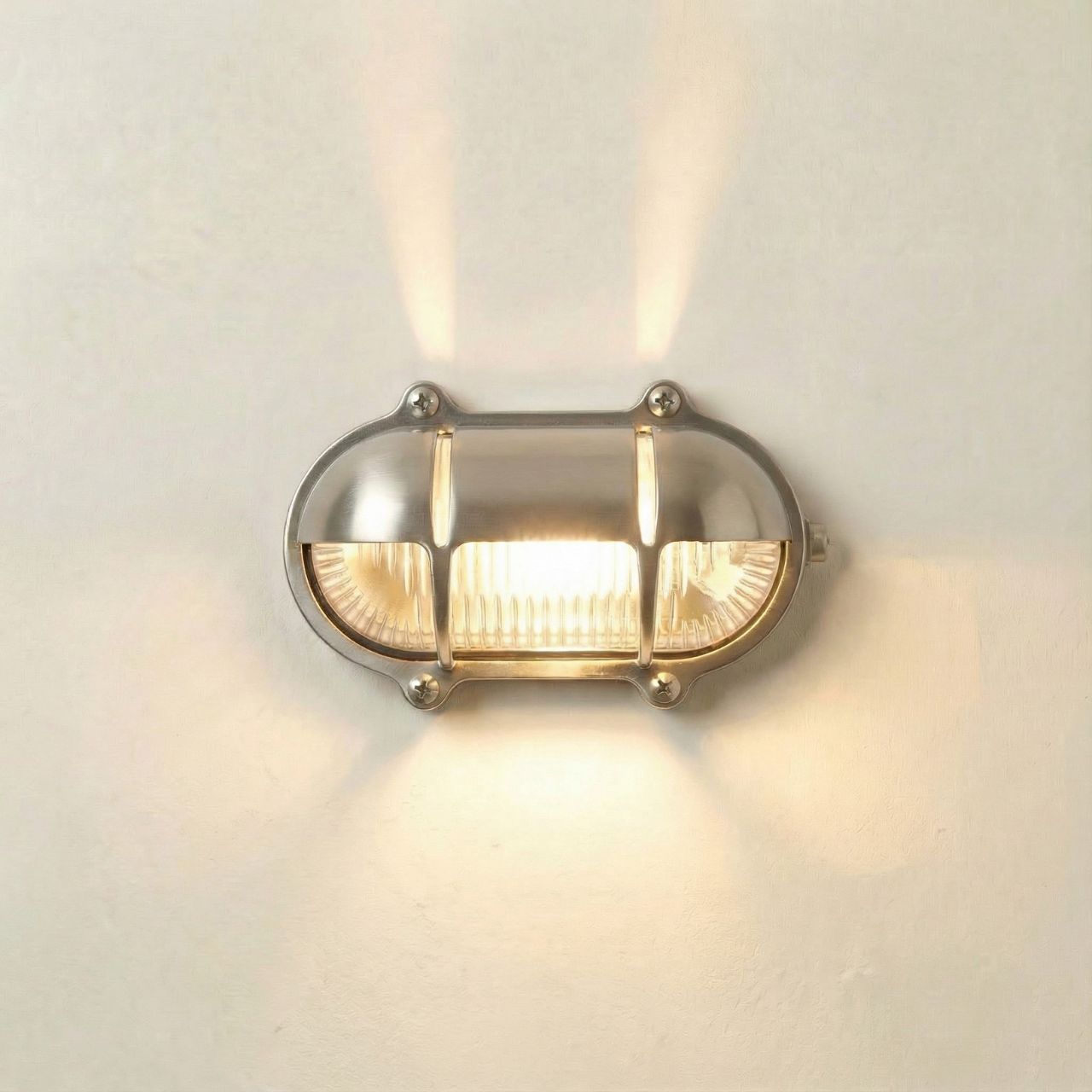 Wall-mounted light fixture with glass cover on a neutral background