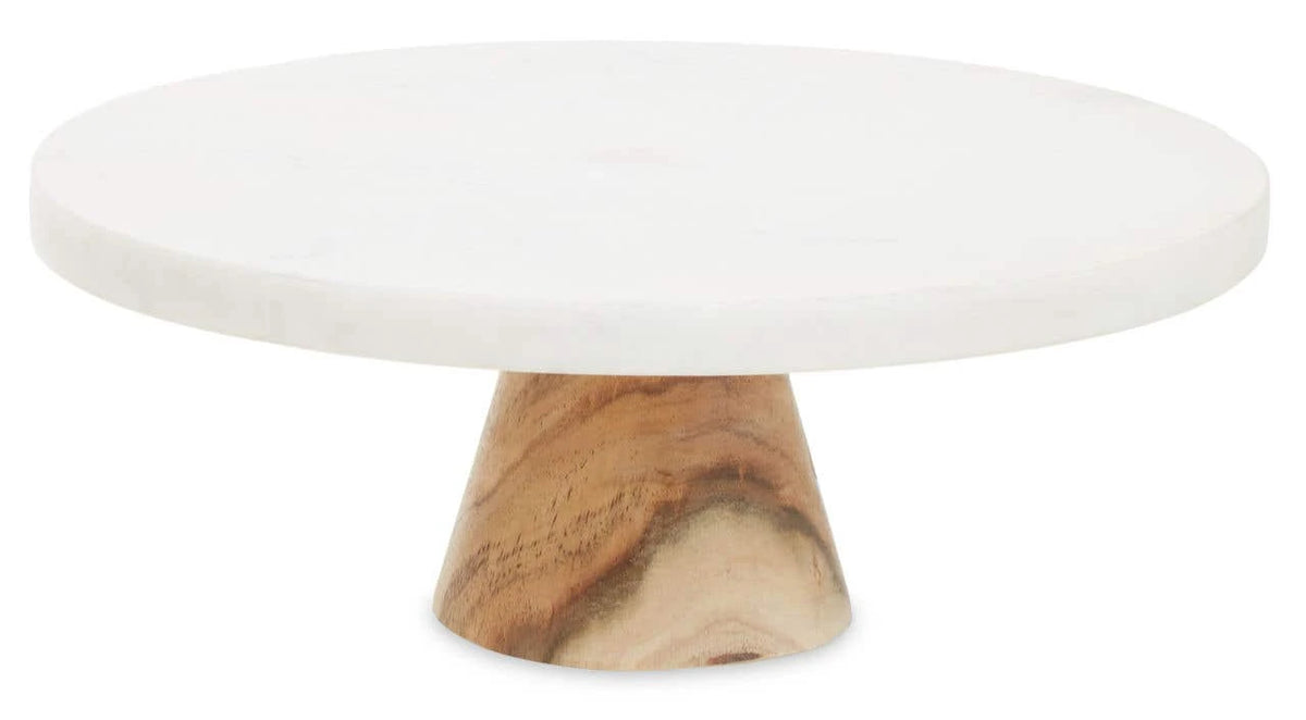 The Loxley Round Cake Stand with a white marble top on a tapered acacia wood pedestal.