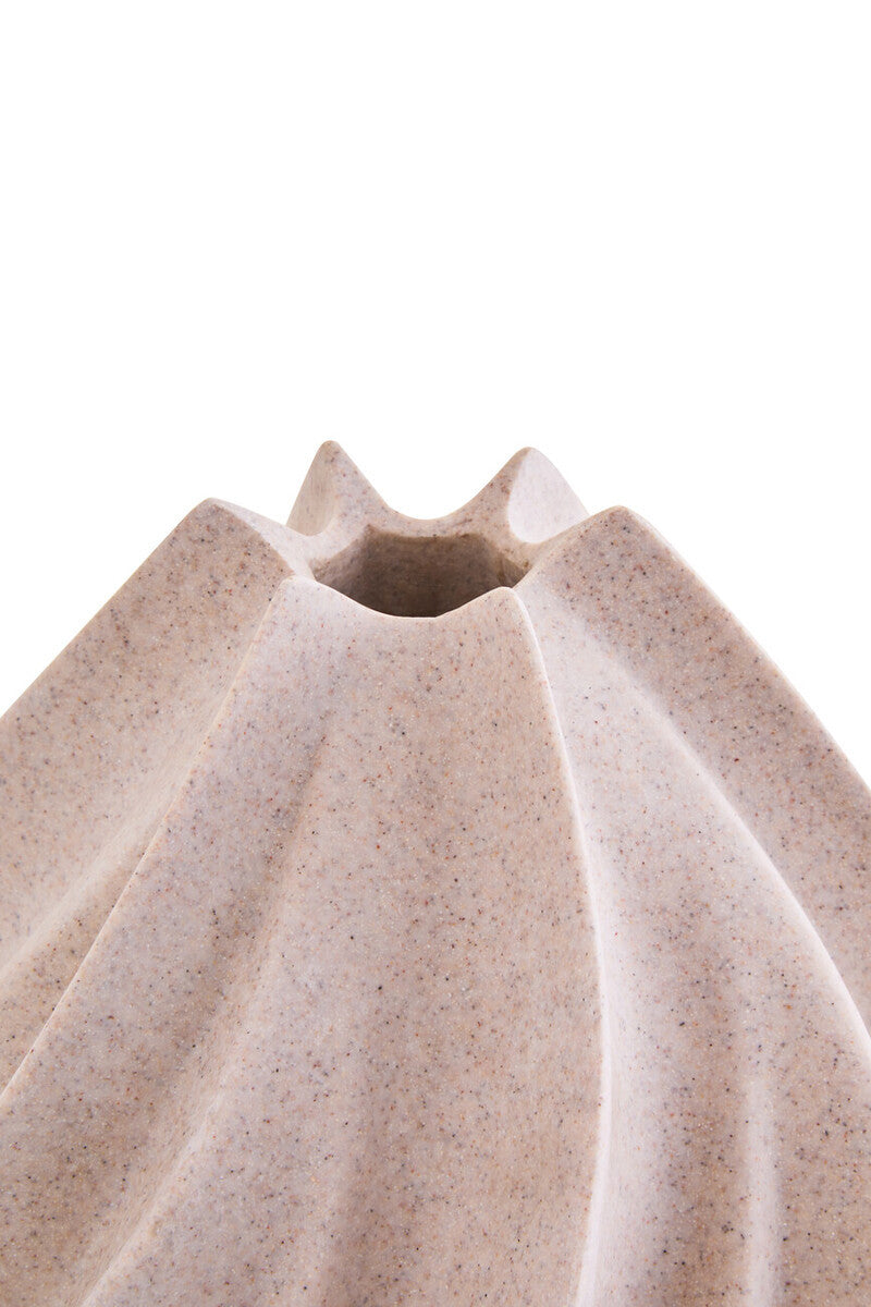 Beige ceramic vase with textured surface on a white background
