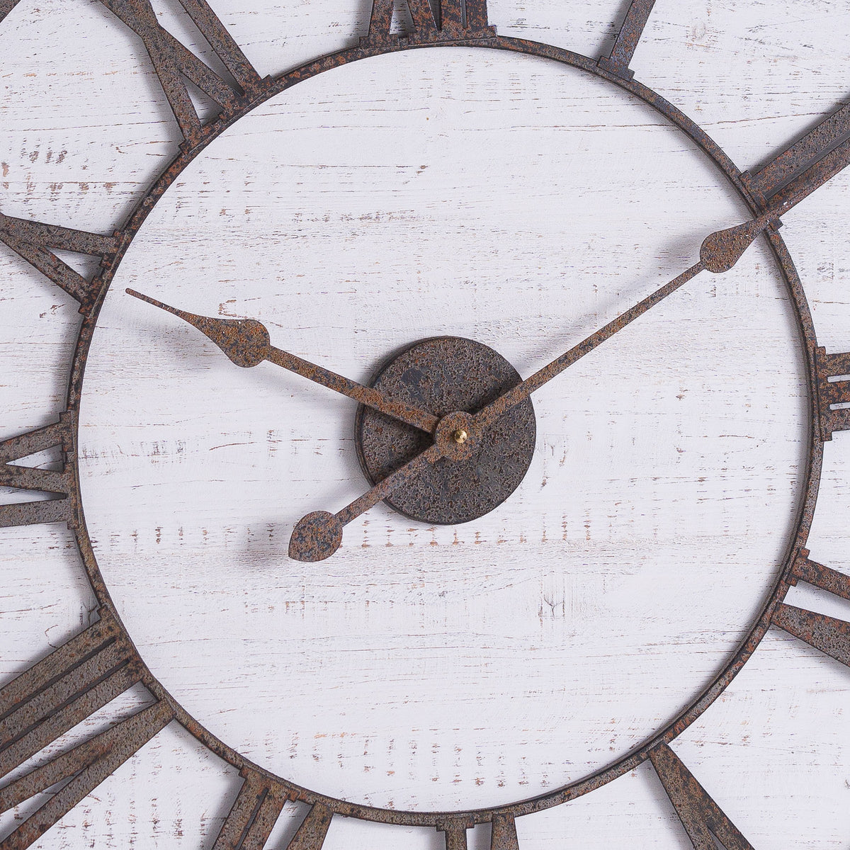 Close-up of the aged metal hands, textured centre plate and distressed white wood on the Rustic Wooden Clock