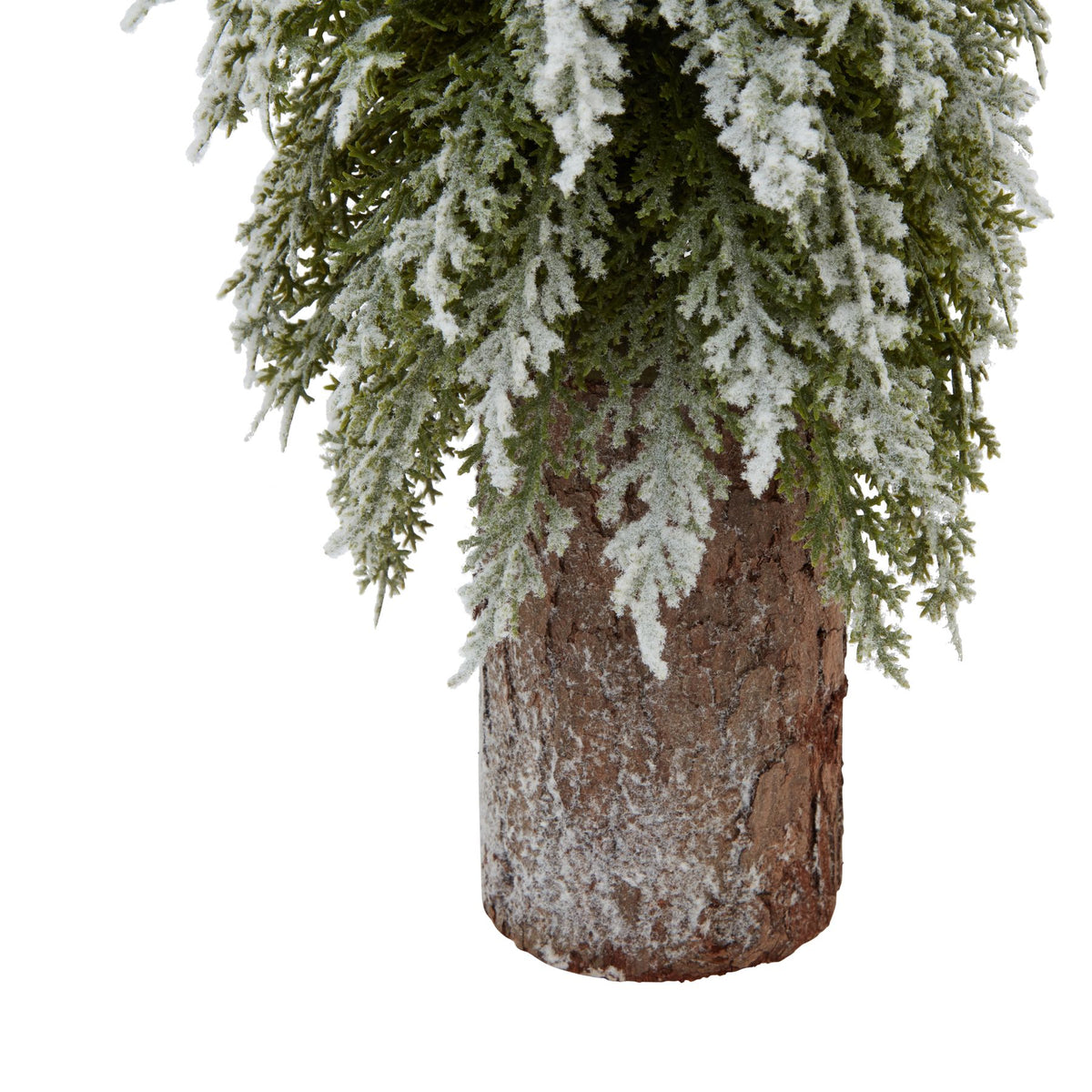 Close-up of the snowy fir branches and bark-covered wood log