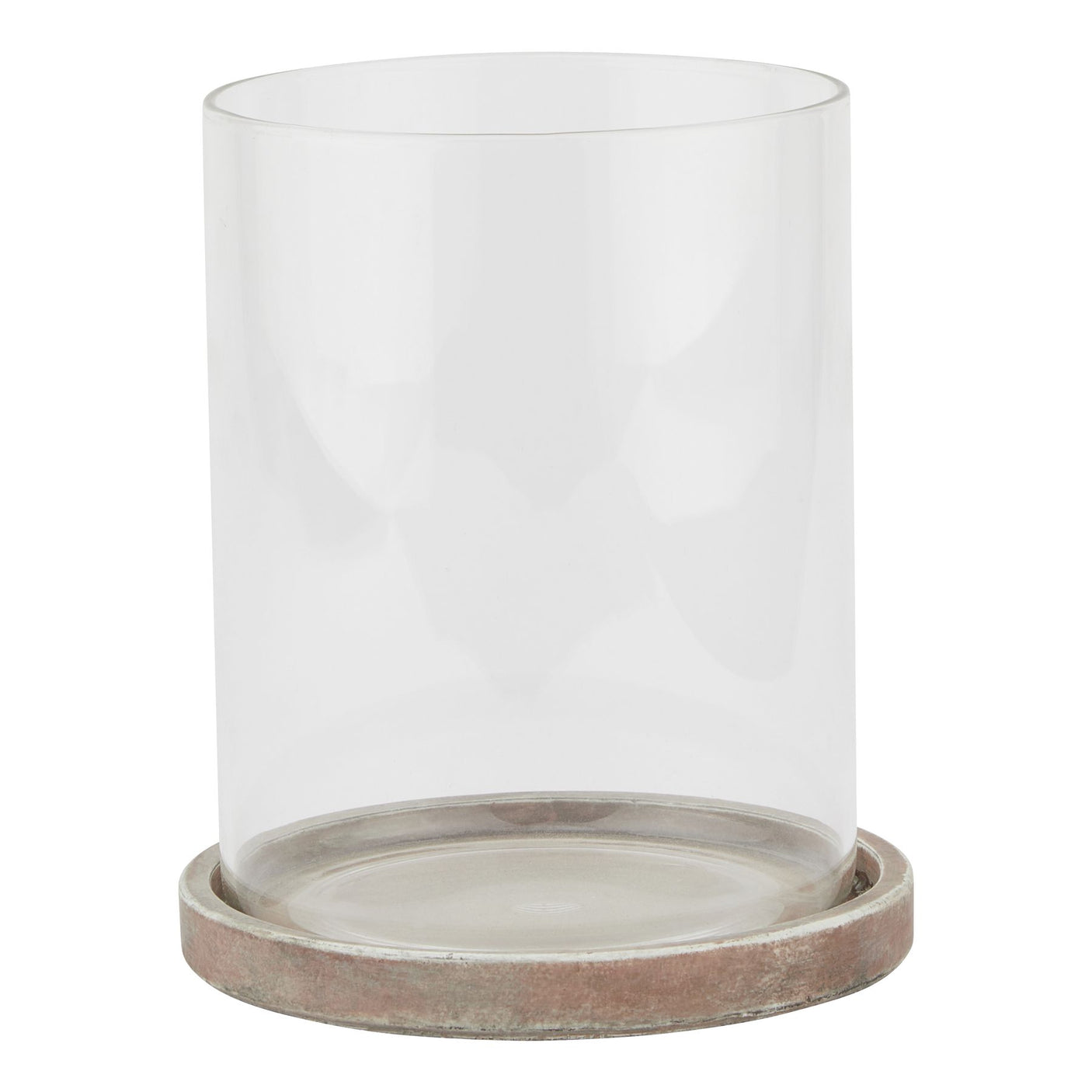 A large hurricane lantern with a brown earthen base and a clear glass cylinder.