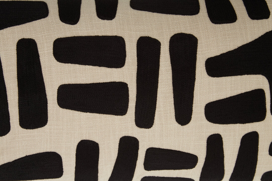 Close-up of the raised black embroidery on the Elora Natural And Black Embroidered Cushion