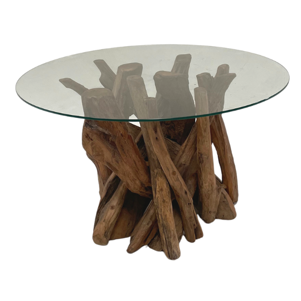 Glass-top table with teak root base on a white background