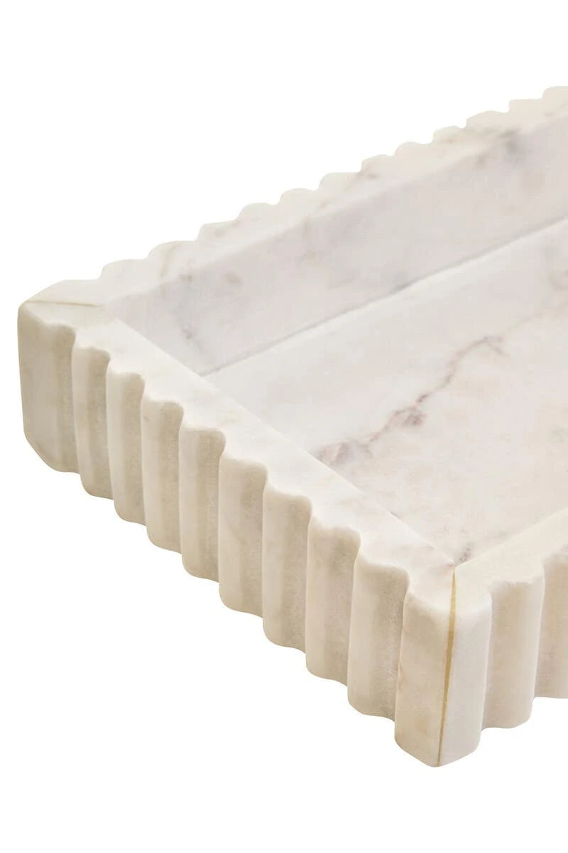 Close-up of a corner of the Vela White Marble Fluted Rectangular Tray, showing the fluting and grey veining in the base.