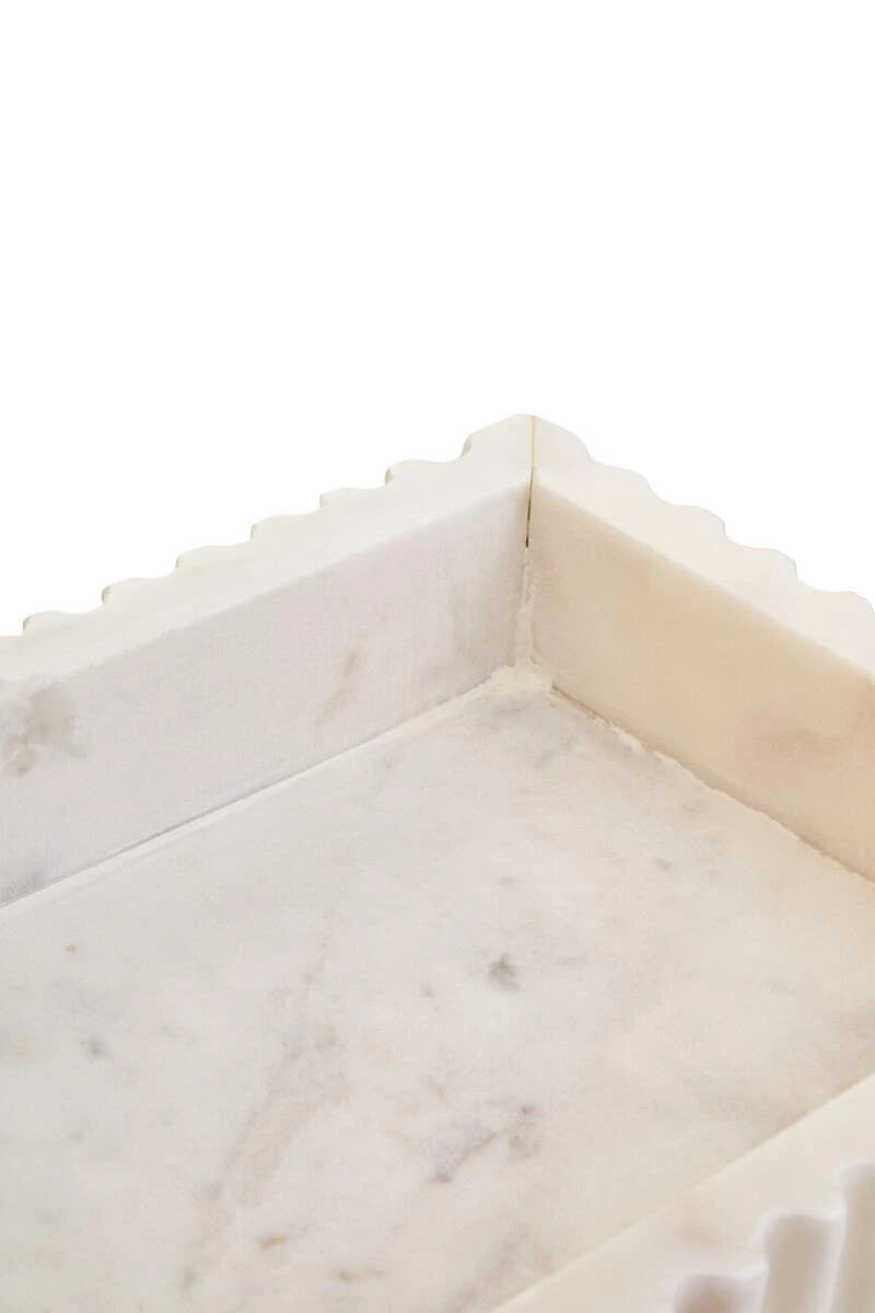 Close-up of the inside corner of the Vela marble tray, showing the smooth base and natural markings.