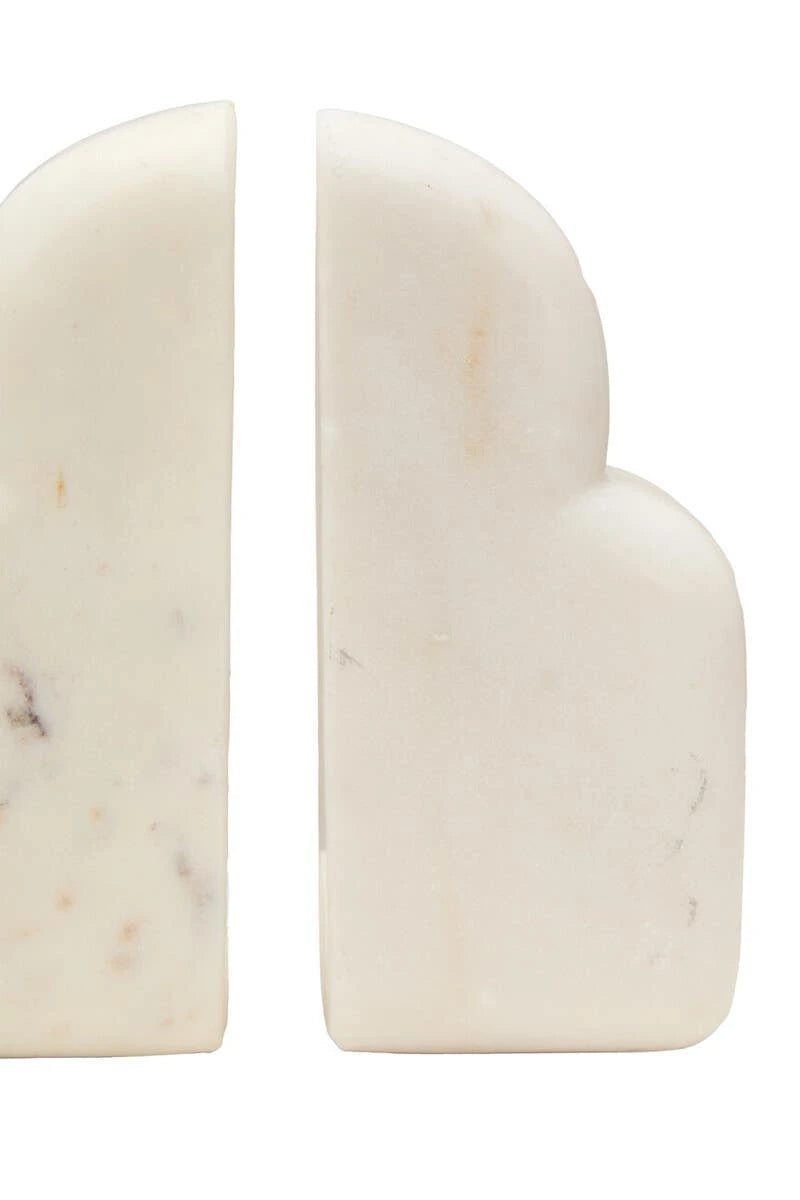 Close view of the Vela white marble bookends, showing the soft grey and blush markings in the stone.