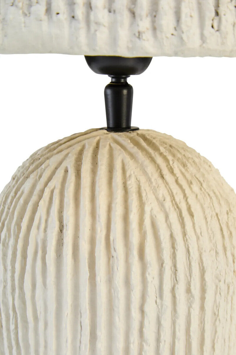 Close-up of a textured lamp with a white base and black fixture on a white background