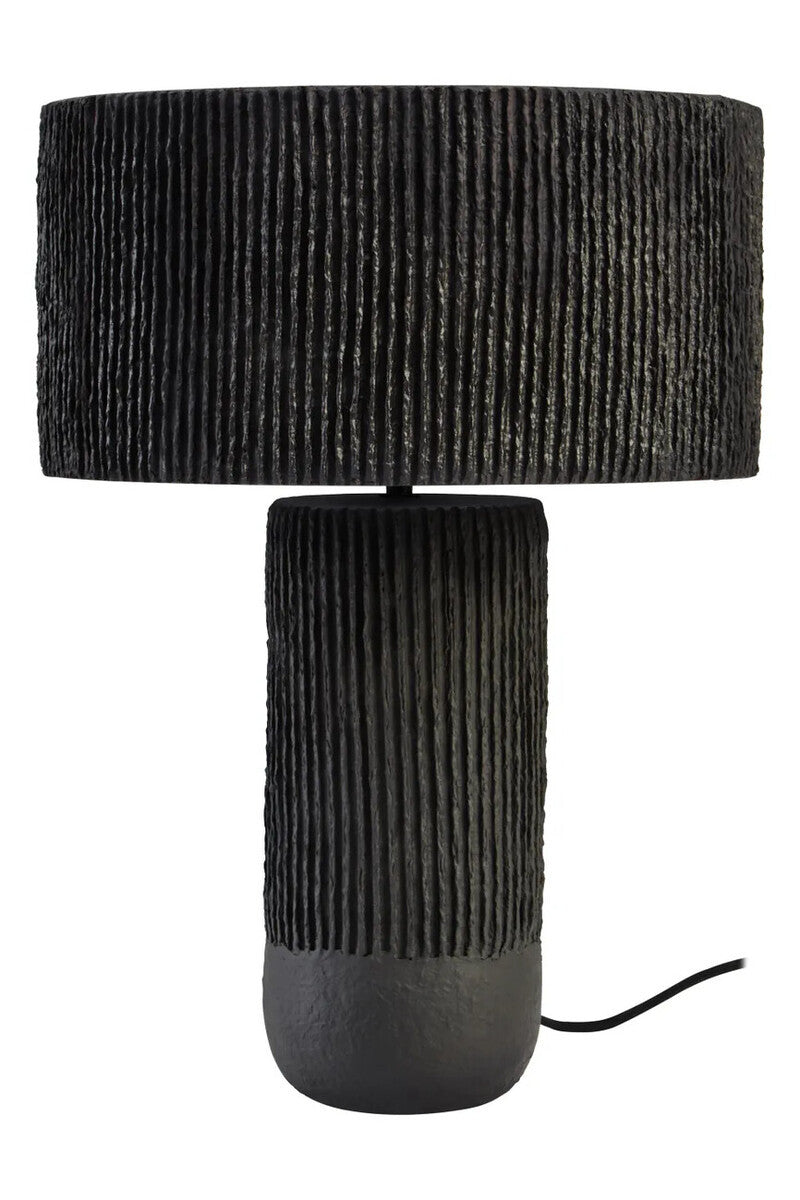 A black ribbed table lamp on a white background