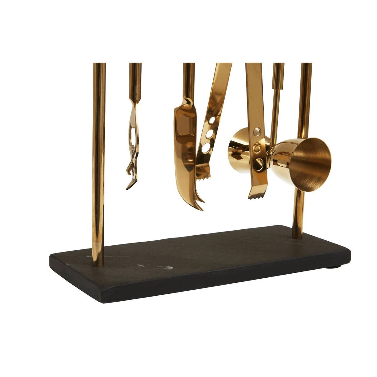 Close-up of the gold-finish tools and black slate base