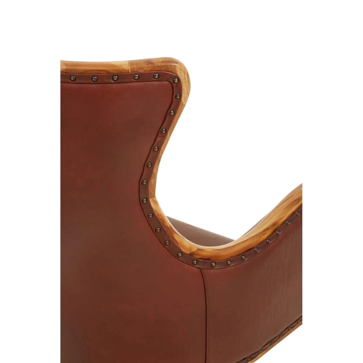 Close-up of the shaped wingback of the Jakarta Studded Chair, with teak edging and a line of antique studs.