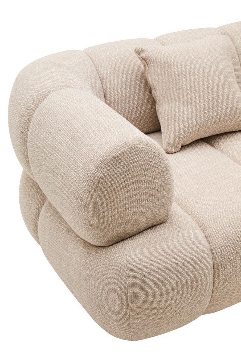Armrest of a rounded cream sofa on a white background