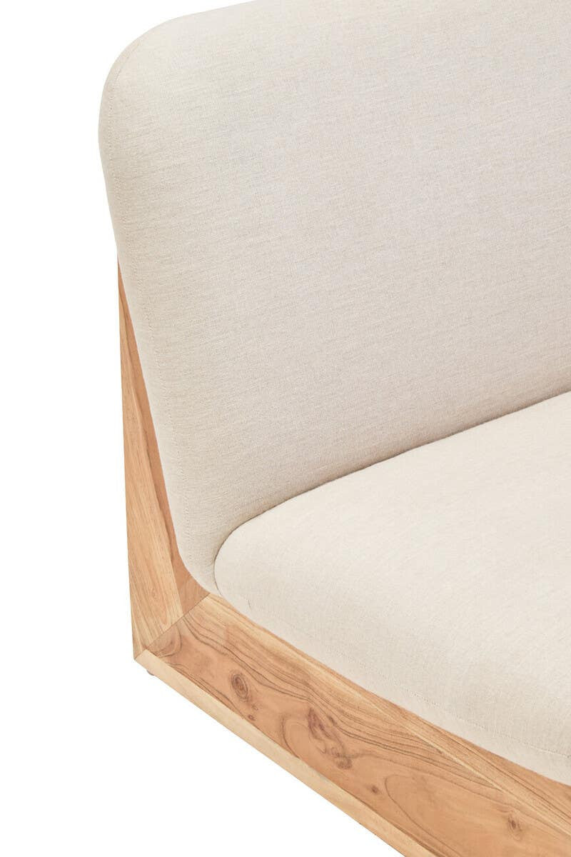 Cream linen armless sofa with wooden base on a white background