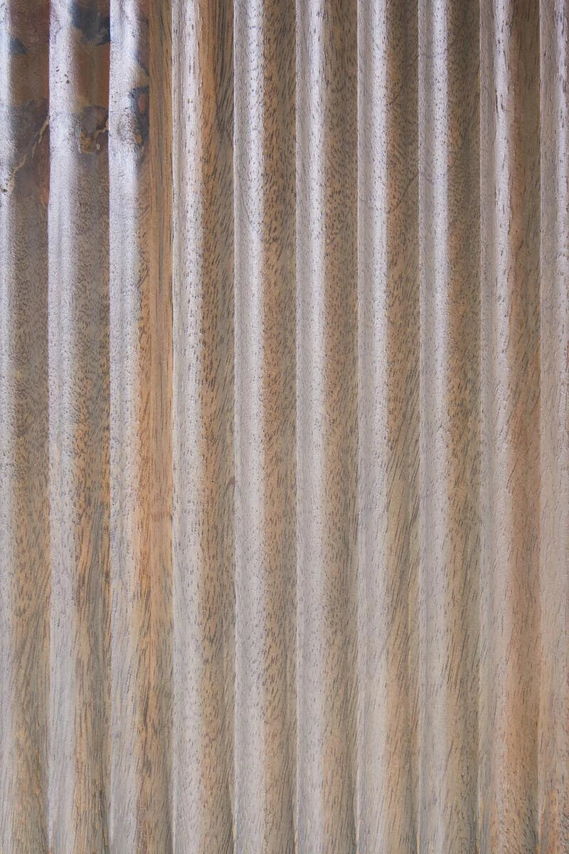 Close-up of the vertical reeding and grey-washed mango wood grain on the Hawthorn shelf unit's centre panel.