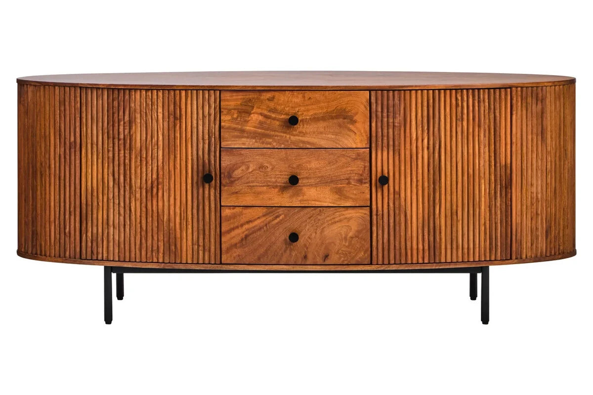 Front view of the Hawthorn Oval Sideboard, with two reeded mango wood doors either side of three drawers with black knobs, on black metal legs.