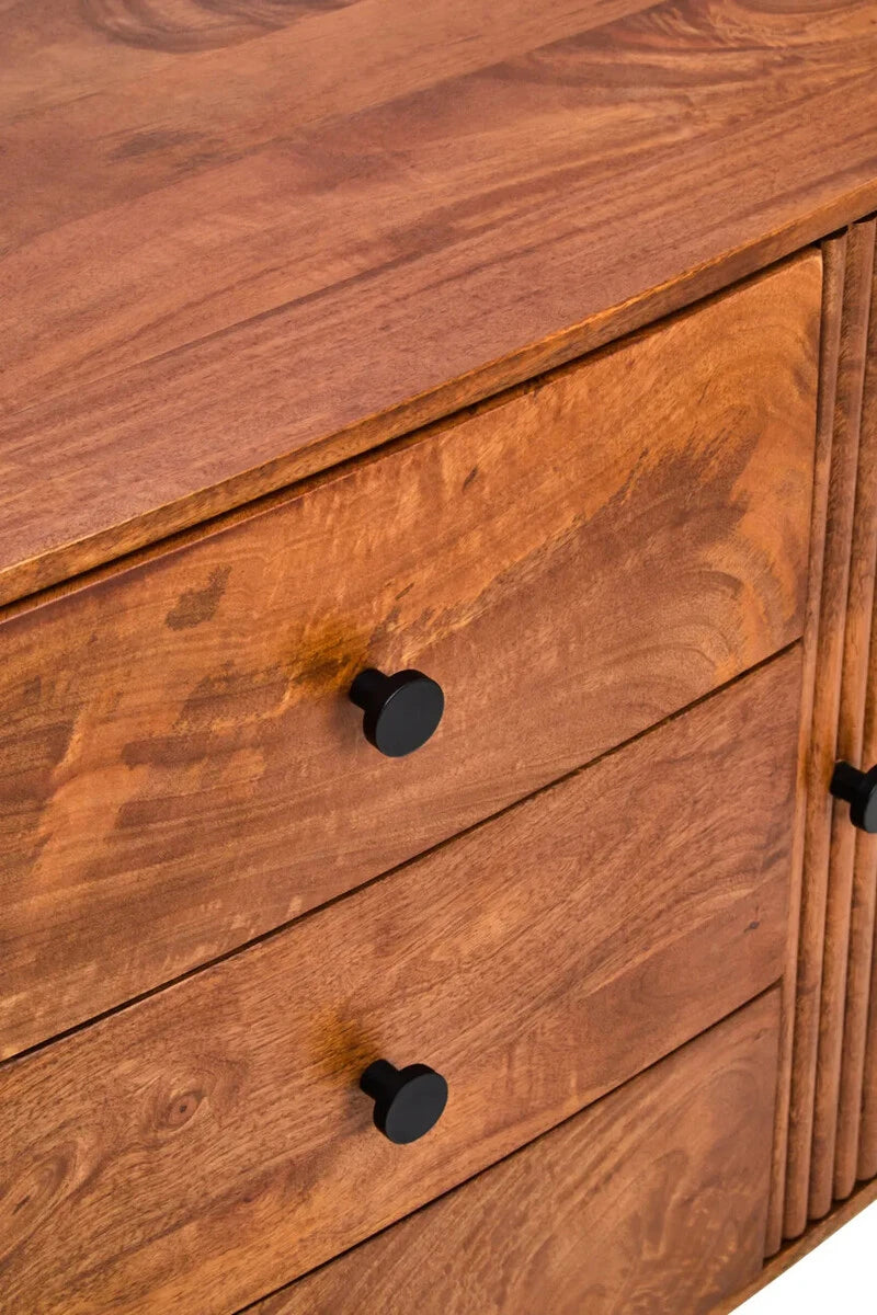 Close-up of the Hawthorn Oval Sideboard drawers with round black knobs and rich mango wood grain.