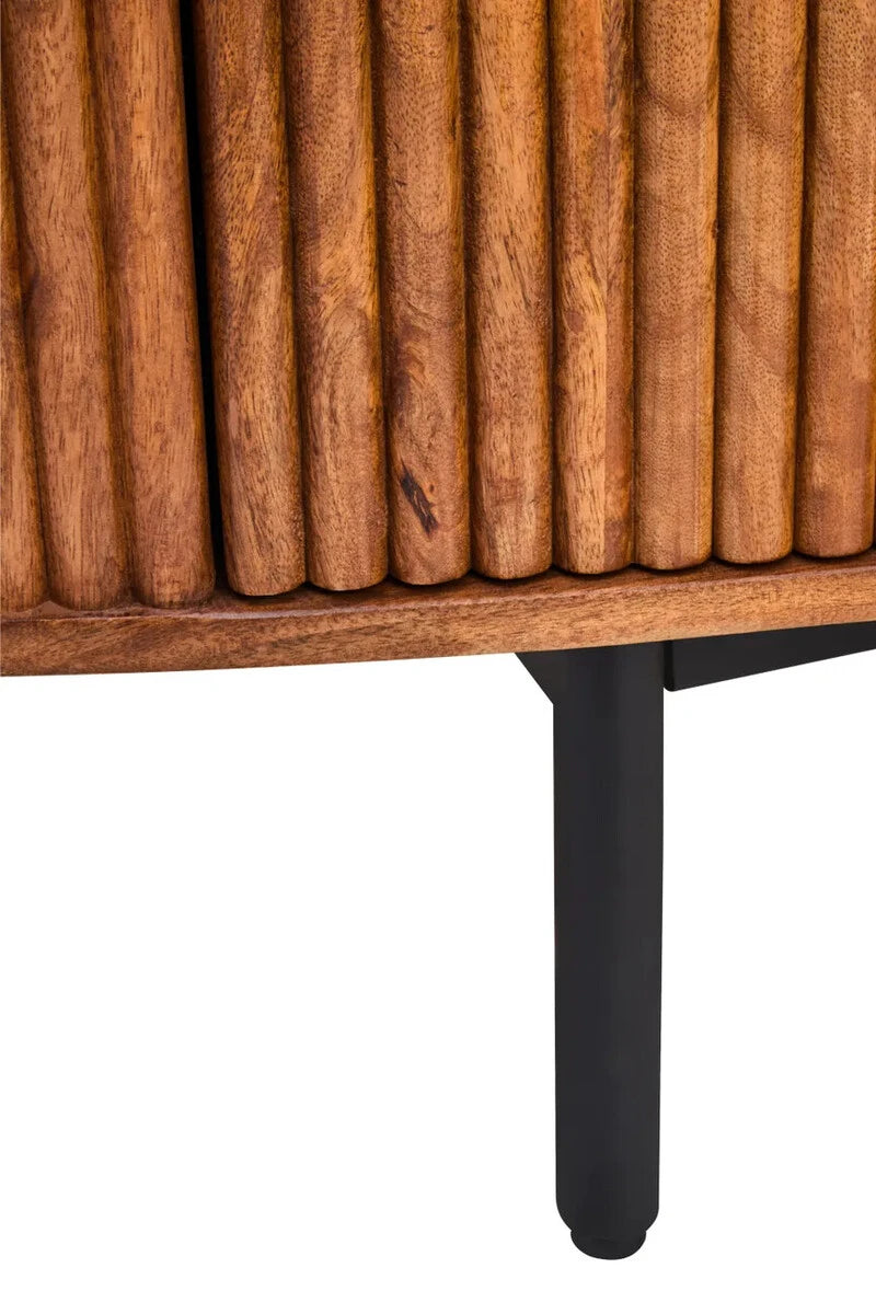 Close-up of the reeded mango wood front and black metal leg of the Hawthorn Oval Sideboard.