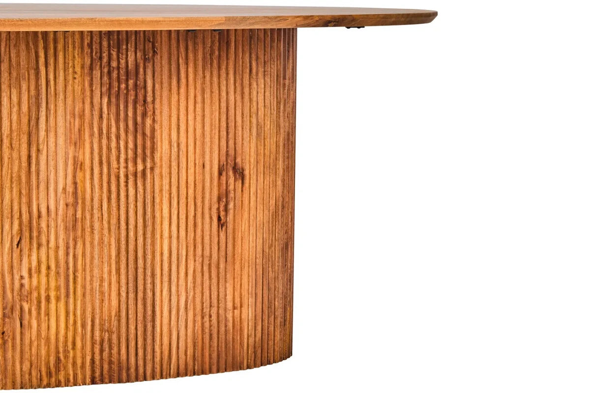 Close view of the Hawthorn dining table's reeded base, showing the vertical fluting and warm mango wood grain.