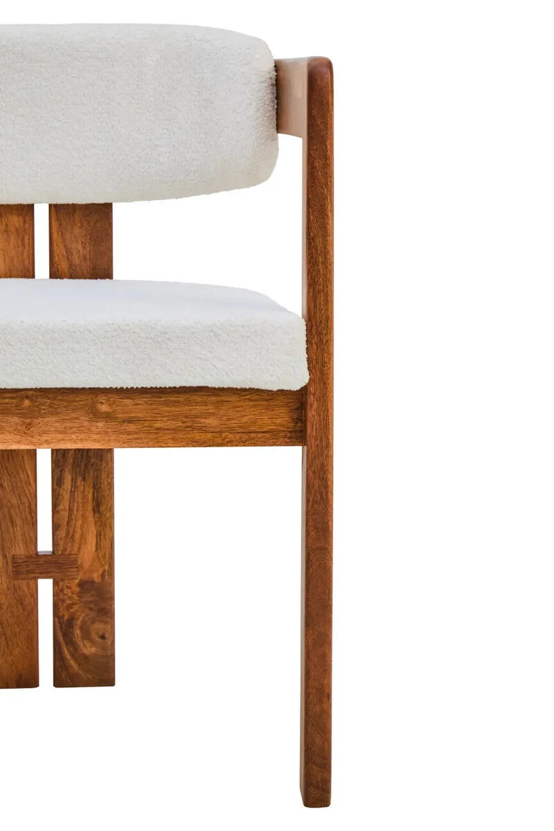 Close view of the Hawthorn Dining Chair front, showing the bouclé seat and the grain of the mango wood back legs.