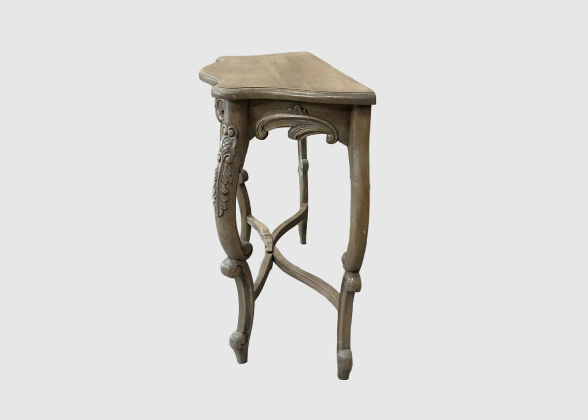 A small carved wooden side table with a hexagonal top and ornate cabriole-style legs, shown against a plain light gray background.