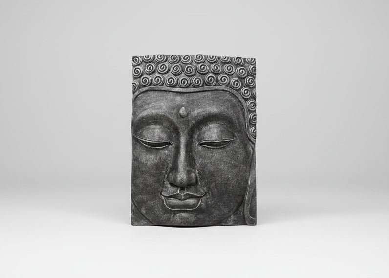 A rectangular dark grey Buddha head wall plaque with detailed sculpted curls on the hair and a serene closed face, shown against a neutral light grey background.