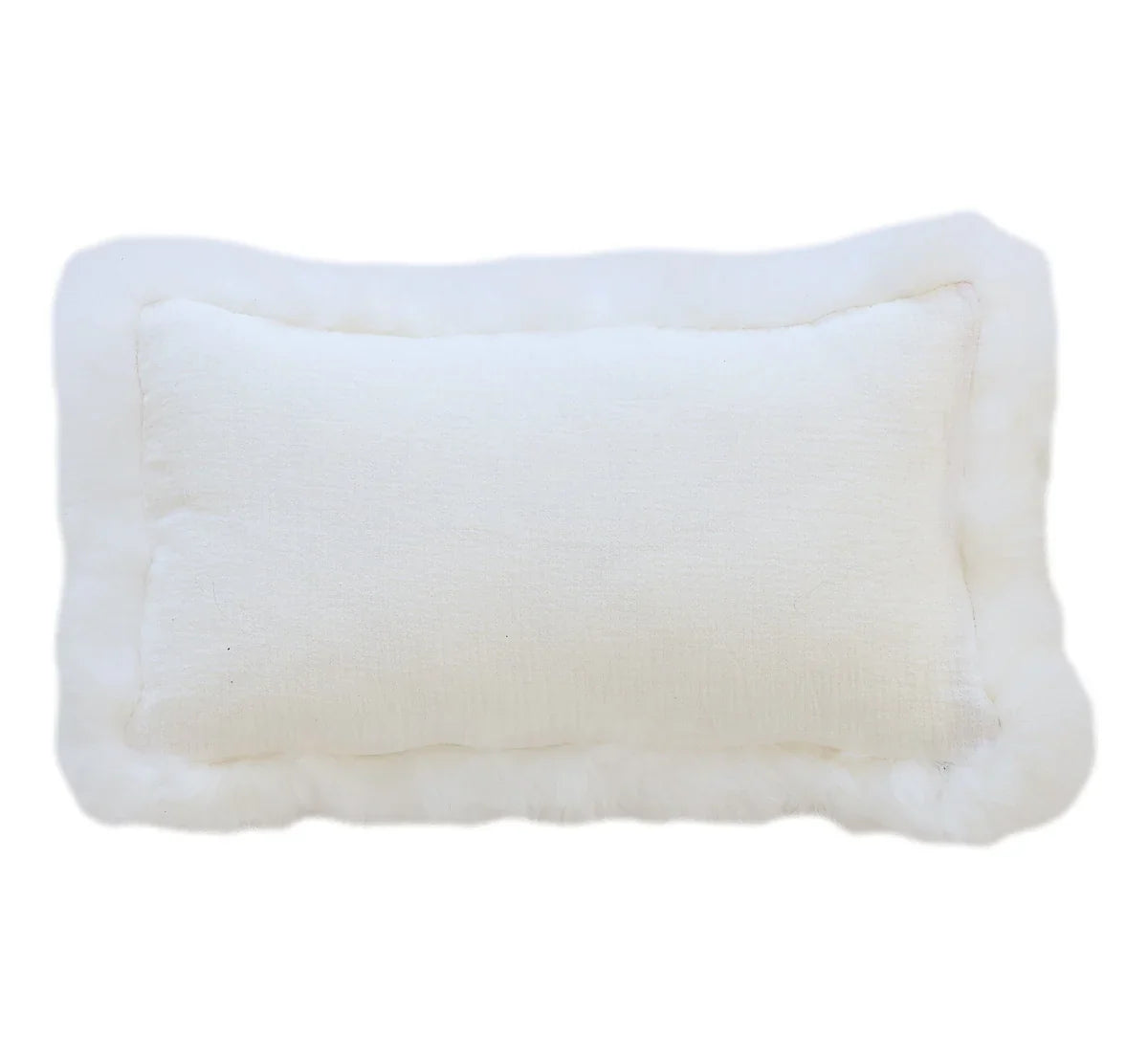 Rectangular White Linen Cushion With Sheepskin Trim in crinkled white linen with a sheepskin border, on a white background