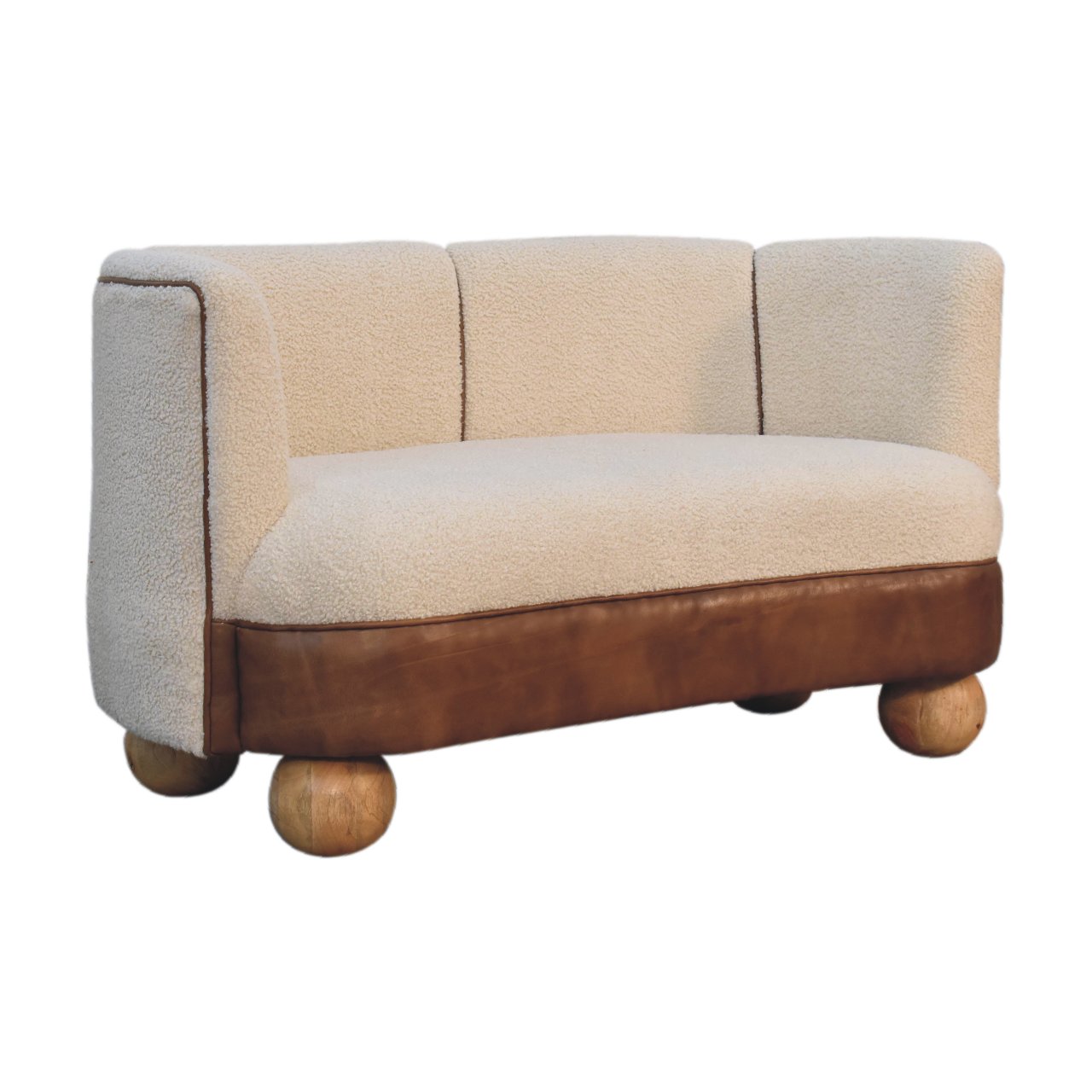 A small boucle sofa with buffalo leather detail and round mango wood legs