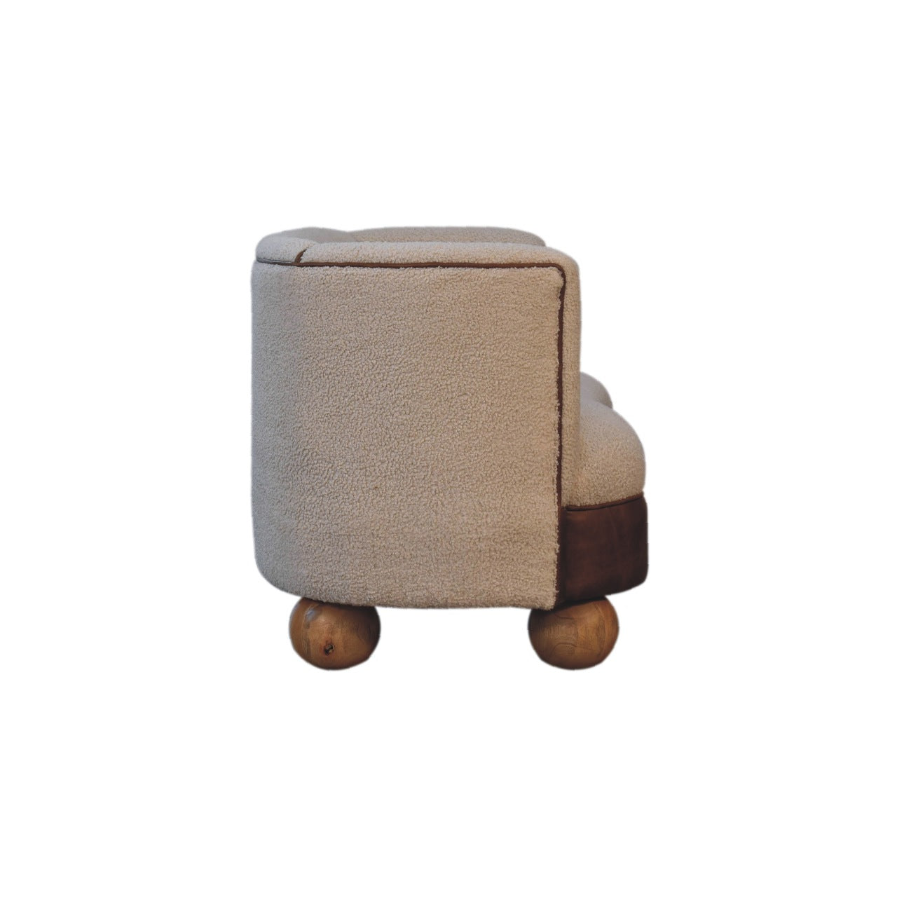 Side view of a cream boucle sofa with mango wood round legs
