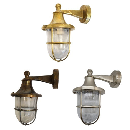 Three wall-mounted outdoor lights in brass, bronze, and silver on a white background.