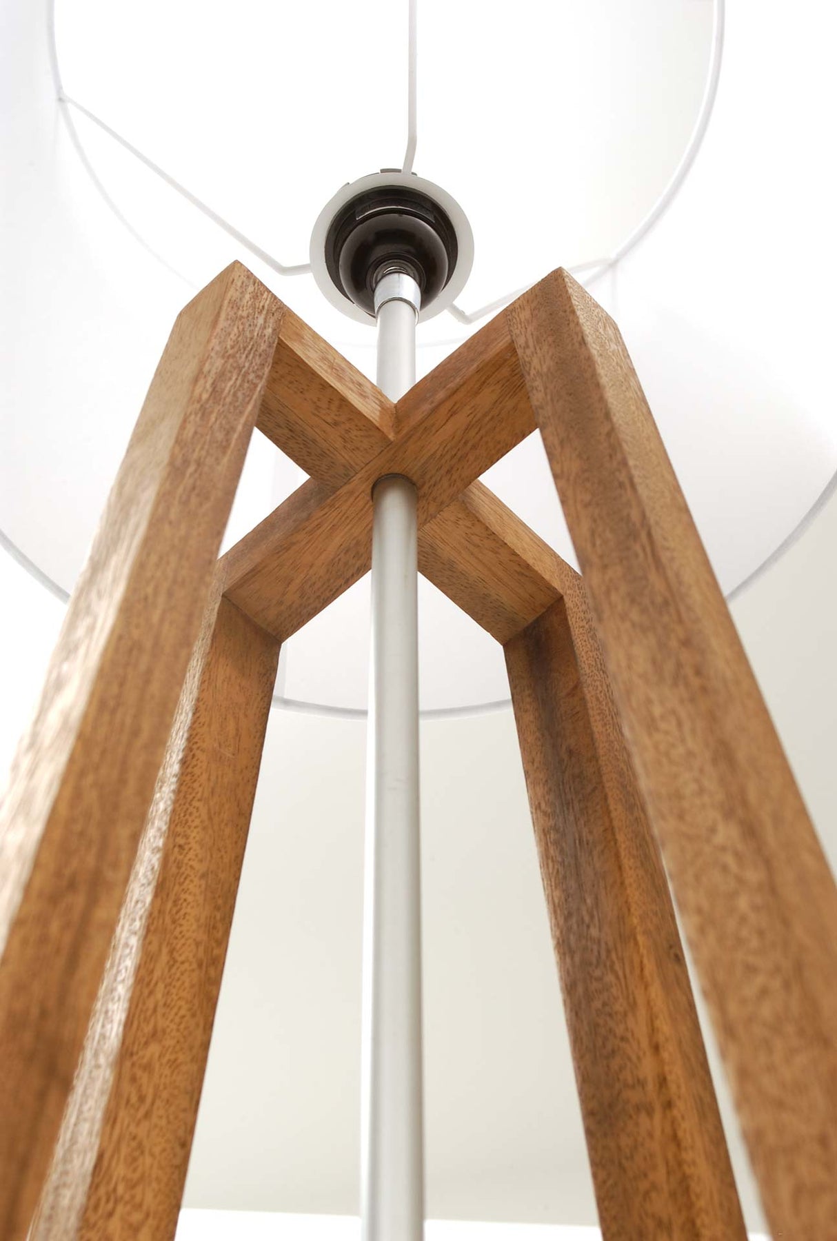 Wooden lamp with cross design on a white background