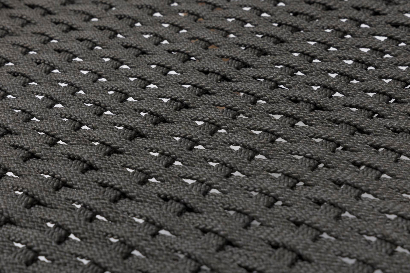 Close-up of a dark grey woven fabric texture with a repeating basketweave pattern.