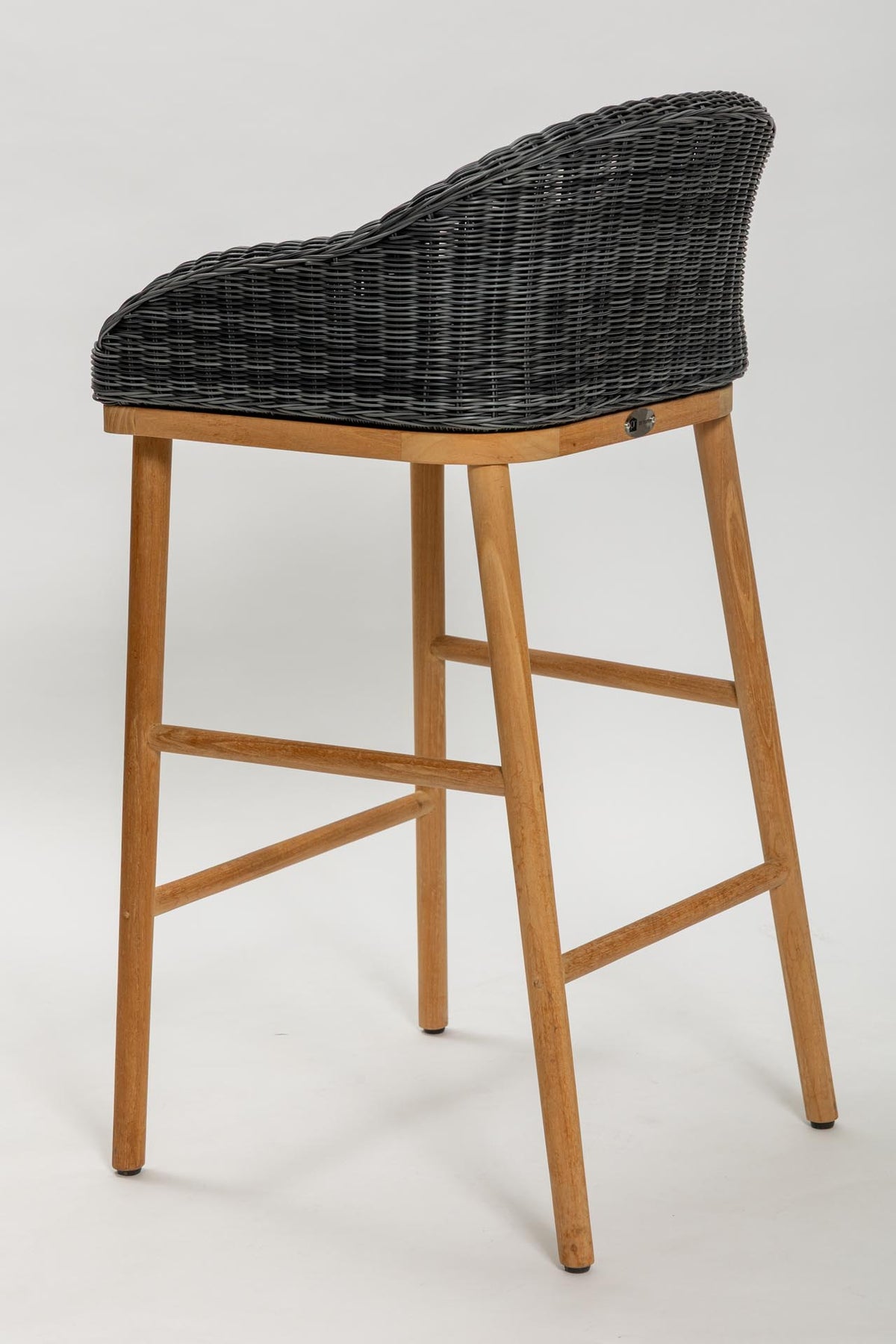 Bar stool with wicker backrest and wooden legs on a white background