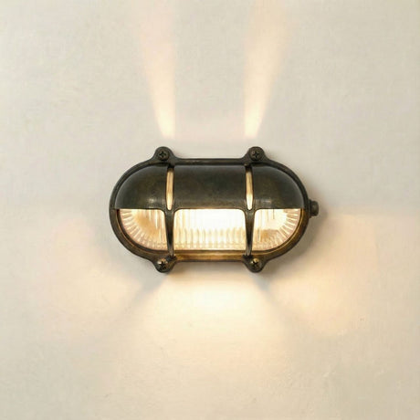 Wall-mounted light fixture with glass cover on a neutral background