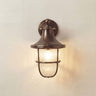 Vintage-style wall-mounted light fixture on a plain wall.