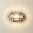 Satin nickel bulkhead style wall light on a textured wall