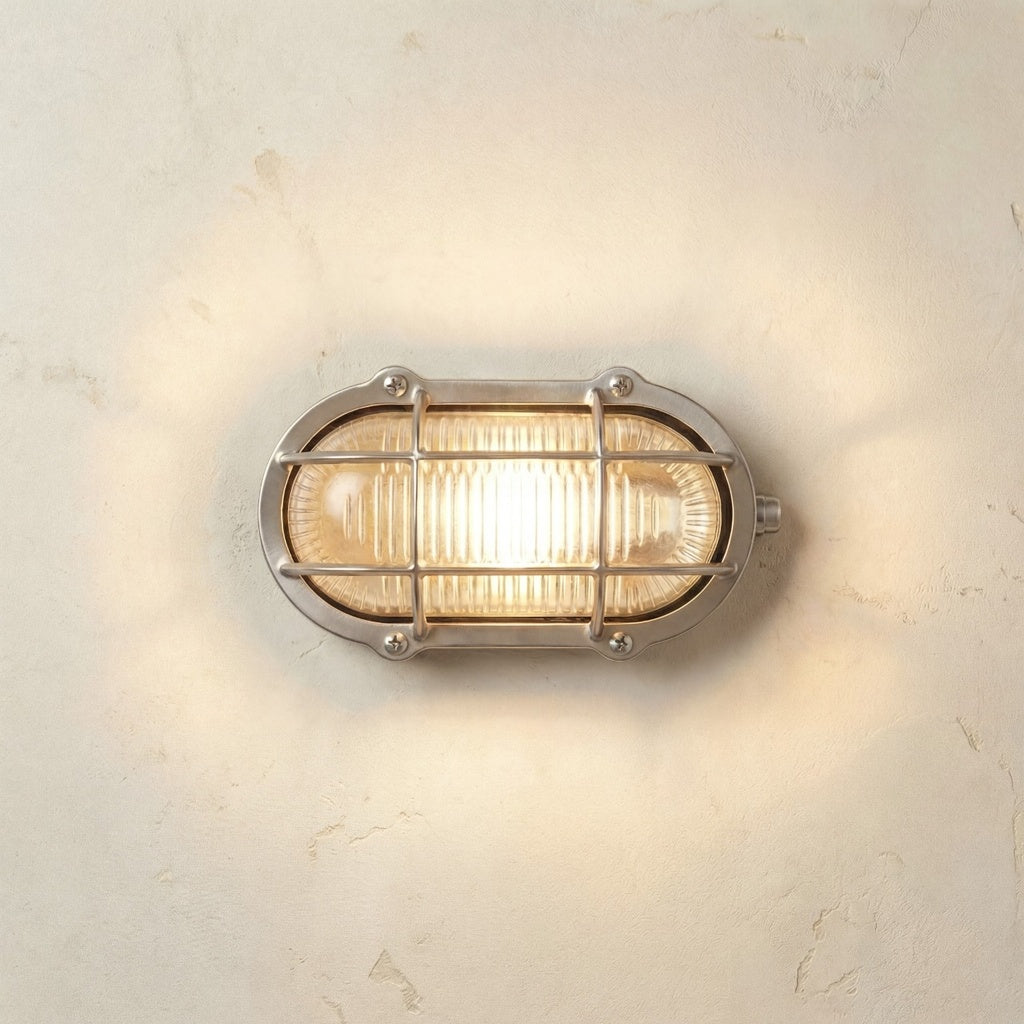 Satin nickel bulkhead style wall light on a textured wall