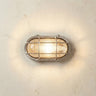Satin nickel bulkhead style wall light on a textured wall