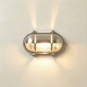 Wall-mounted light fixture with glass cover on a neutral background
