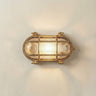 Horatio junior bulkhead outdoor wall light in raw brass on a neutral wall