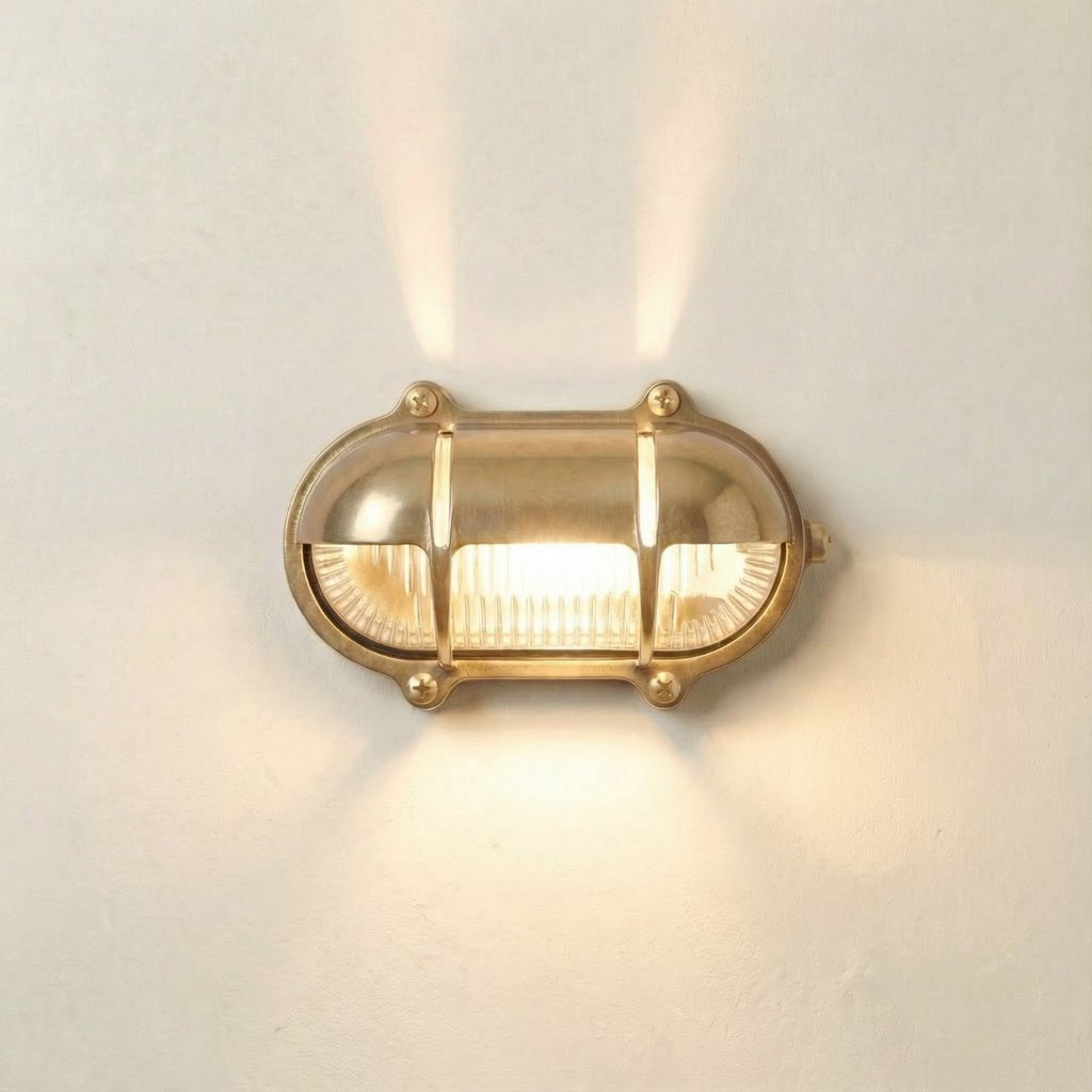 Gold wall light fixture on a white wall