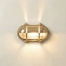 Gold wall light fixture on a white wall