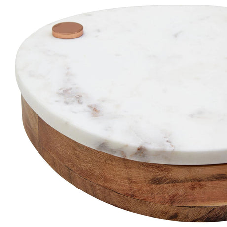 Close-up of the copper-finish pivot on the white marble top of the Loxley Cheese Board.