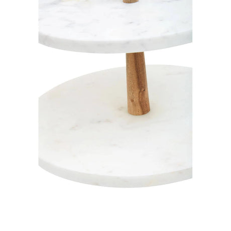Close-up of the acacia wood post between the two marble tiers of the Loxley Cake Stand.
