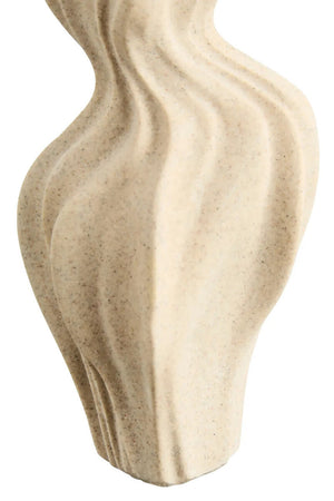 Close up of a wavy textured beige vase on a white background