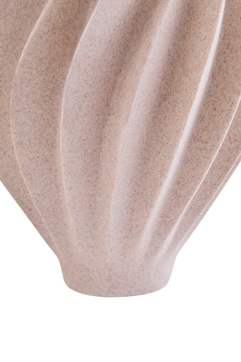 Close-up of a ribbed ceramic vase in a speckled beige and light brown glaze, showing its textured surface and curved fluted design against a white background.