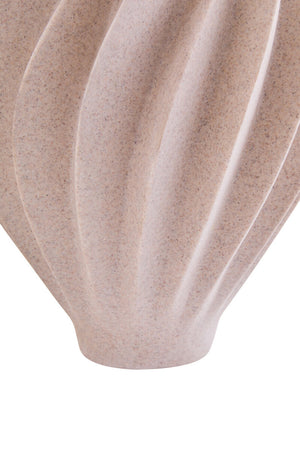 Close-up of a ribbed ceramic vase in a speckled beige and light brown glaze, showing its textured surface and curved fluted design against a white background.
