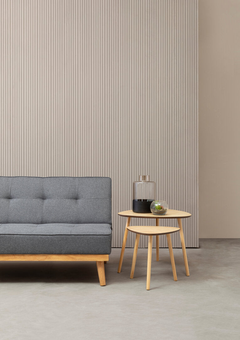 Skagen grey fabric sofa bed with a neutral background and styled with a set of two side tables