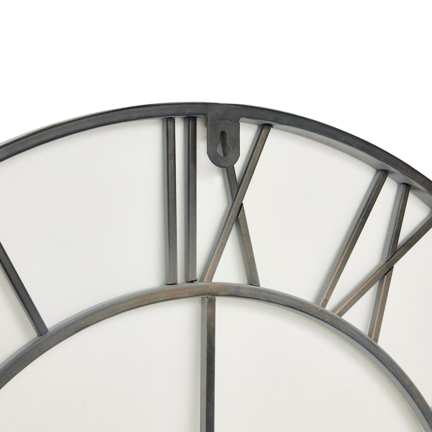 Close up of a grey skeleton wall clock with roman numerals