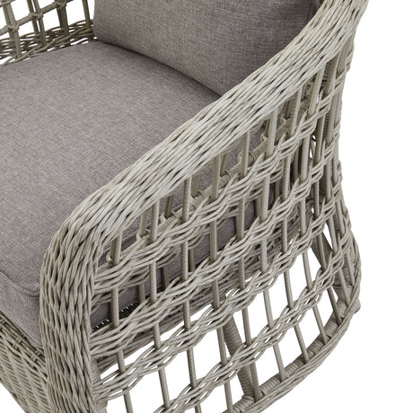 Wicker chair with grey cushions on a white background