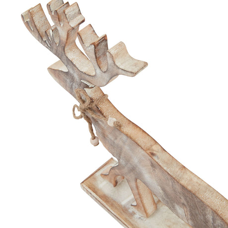 Close-up of the whitewashed wooden stag's antlers